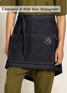 a man wearing an apron with the words customize it with your monogramm