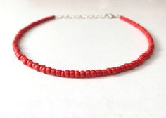 This red bead necklace is 100% handmade with beautiful glass seed beads. It can be made either 14, 16, 18, or 20 inches long, and each necklace comes with additional extender chain, making it easily adjustable. This necklace goes great with so many outfits- dress it up for a fancier event, or wear it with jeans and a t-shirt. It also makes a simple yet amazing gift for a family member, friend or loved one! Handmade Red Beaded Choker Necklace, Handmade Adjustable Red Choker, Red Beaded Necklaces With Tiny Beads As Gift, Adjustable Red Choker With Tiny Beads, Adjustable Handmade Red Choker, Red Handmade Choker For Festivals, Red Beaded Choker Necklaces For Festival, Red Beaded Choker Necklace For Festivals, Red Spacer Beads For Festival