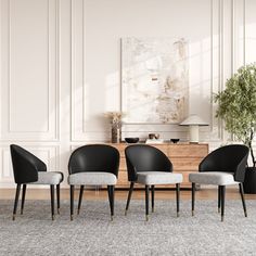 four black and white chairs sitting in front of a table