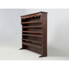 an old wooden book shelf with many shelves