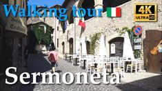 a person walking down a cobblestone street in front of an italian flag and the words walking tour