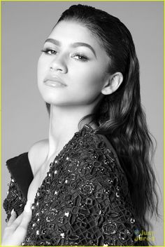 a black and white photo of a woman with long hair wearing a sequin dress