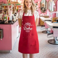 a woman in an apron is posing for the camera