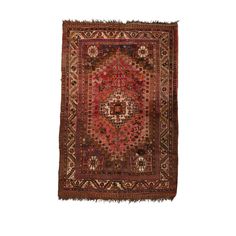 an old rug with fringes on the edges and a medallion design in red, brown and beige colors