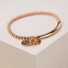 Our pretty 14ct rose gold filled beaded bracelet is so sweet and handmade in our studio on the Isle of Wight. Personalise your bracelet with a polished disc, a sweet message of up to 25 characters for that extra special touch, this comes as standard. Please add your chosen personalisation into the pox provided below. It is a gorgeous gift idea for a special girl in your life! Our gorgeous rose gold filled bracelet comes in a pretty, signature grey gift box making a perfect gift to give. * Stretc Elegant Beaded Bracelets With Flower Charm As Gift, Rose Gold Beaded Bracelets As Gift, Elegant Personalized Rose Gold Beaded Bracelets, Dainty Rose Gold Name Bracelet, Elegant Personalized Rose Gold Beaded Bracelet, Rose Gold Dainty Charm Bracelet Gift For Her, Minimalist Rose Gold Bracelets For Valentine's Day, Minimalist Rose Gold Bracelet For Valentine's Day, Rose Gold Round Bracelets As Gift For Her