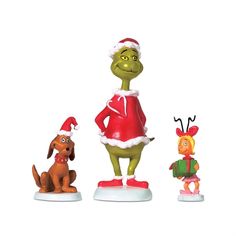 three christmas figurines including a dog, santa hat and elf outfit on white background