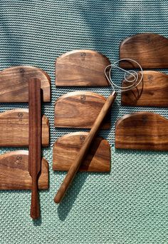 four wooden cutting boards and a whisk on a blue cloth with a green background