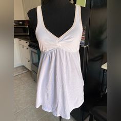 Y2k Abercrombie White Babydoll Tank Top Tunic With A Light Pinkish/Peach Around Back Neckline And Chest Line. Size Small. But Could Fit A Medium As Well. Bigger Chest Friendly. Nwt But Did Have A Small Hole At The Lower Half Side Of The Top That I Stitched Up, Shown In Very Last Pic. Fitted Cotton V-neck Sleepwear, White V-neck Tops For Sleepover, White Stretch Sleeveless Sleepwear, White Sleeveless Stretch Sleepwear, V-neck Tops For Spring Sleepover, V-neck Tops For Sleepover In Spring, Cotton V-neck Top For Bedtime, Casual Camisole Top For Sleepwear, White Stretch Tops For Bedtime