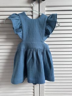 "Dress made of muslin cotton fabric with ruffled braces. The dress has an elasticated waist for a perfect fit.  Avalible sizes (child height ):  1 year (approx. height 31\"/80cm)  2 years (approx. height 34\"/86cm)  3 years (approx. height 37\"/92cm)  4 years (approx. height 40\"/104cm)  5 years (approx. height 43\"/110cm) The item is made to order and it takes about 3-7 days to go and will be shipped immediately when it will be ready. I will inform you by e-mail, when your package has been sent. If you have any questions, please contact me. Like us on Facebook for more photos https://www.facebook.com/pages/Lilly-Rose/406459142796041 THANK YOU FOR VISITING LILLY ROSE" Cotton Ruffle Dress With Flutter Sleeves For Summer, Summer Cotton Ruffle Dress With Flutter Sleeves, Cotton Sundress With Ruffled Straps, Summer Cotton Sundress With Ruffled Straps, Cotton Ruffle Dress With Flutter Sleeve, Casual Cotton Ruffle Dress With Ruffle Sleeves, Casual Cotton Ruffle Dress With Flutter Sleeves, Sleeveless Cotton Ruffle Summer Dress, Casual Cotton Suspender Dress With Ruffles