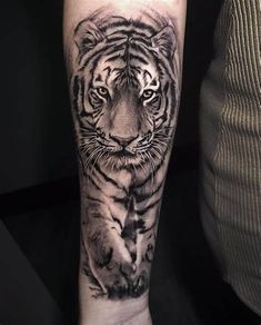 a black and white tiger tattoo on the arm