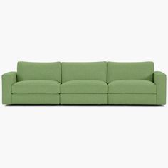 a green couch sitting on top of a white floor