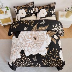 a bed with black and white flowers on it