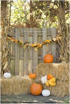 hay bales with pumpkins and flowers on them