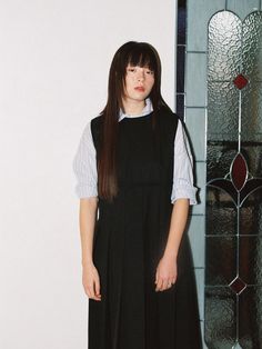 This is a Gatsby dress inspired by the look of female students from the Bauhaus era of the 1920s. It features a straight fit dress with pleats for added mobility, making it suitable for layering with a t-shirt or shirt due to its semi-oversized fit.- Delicate shirring detail adds a touch of elegance to the bottom hem of the sleeves, giving the garment a stylish twist.- An elastic banding at the waist ensures a comfortable and flexible fit, allowing you to move freely throughout the day.- The pre Classic Black Pleated Dress For Work, Classic Pleated Dress With Accordion Pleats For Workwear, Black Accordion Pleat Dress For Work, Gatsby Dress, Dress With Pleats, The Bauhaus, The 1920s, Fit Dress, Gatsby