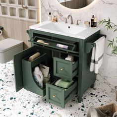 a bathroom with a sink, mirror and green cabinetry in it's center