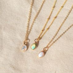 Our Dainty gemstone necklace features a tiny little stone, choose between opal, moonstone and turquoise. …………………………………. Details: Pendant is Genuine Turquoise, Genuine Moonstone, or Synthetic Opal, measuring 5 x 7mm Available in 14k Gold Filled or Sterling Silver Waterproof and can be worn everyday Average necklace length is 18" About Your Jewelry If you are not wearing your jewelry it is best to store it in a cool, dry place such as your gift box that is included in your order. Everyday Opal Jewelry With Gemstones, Everyday Opal Gemstone Jewelry, Dainty Gemstone Charm Necklace For Everyday, Minimalist Moonstone Necklace With Delicate Chain, Delicate Moonstone Necklace With Delicate Chain, Bohemian Moonstone Birthstone Necklace, Delicate Gemstone Charm Necklace With Round Pendant, Minimalist Necklace With Moon Charm For Healing, Delicate Opal Gemstone Jewelry