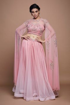 Pastel pink net gathered lehenga with sequins and beaded hand embroidered waistband. Comes with a padded blouse with cape sleeves.
Components: 2
Pattern: Hand embroidered
Type Of Work: Sequins, Beads
Neckline: Round
Sleeve Type: Cape Sleeves
Fabric: Net, Lining : Crepe
Color: Pink
Other Details: 
Attached lining
Lehenga length : 43 inches
Approx Product Weight : 1.5 - 2.5 Kgs
Closure :
Lehenga : Side zip
Blouse : Back hooks
Occasion: Destination Wedding - Aza Fashions Cape Sleeve Lehenga Blouse, Blouse With Cape, Gathered Lehenga, Lehenga Images, Hand Embroidered Blouse, Lehenga Pattern, Padded Blouse, Fashion Sewing Tutorials, Lehenga Blouse