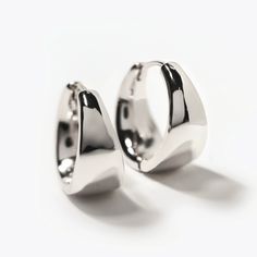 These statement small hoops feature a unique teardrop silhouette, adding a feminine twist to a bold look. Elevate your style and make a statement with these luxurious Sterling Silver hoop earrings. Sterling Silver Inside Diameter 0.5in(13mm), Width 0.3in(8mm) Click closure E190-13S Modern Metal Hoop Huggie Earrings, Modern Metal Small Hoop Huggie Earrings, Modern Small Hoop Metal Huggie Earrings, Chic Drop Hoop Earrings, Modern Round Metal Huggie Earrings, Modern Metal Huggie Earrings, Modern Round Huggie Earrings, Chic Silver Hoop Earrings Tarnish Resistant, Modern Twist Hypoallergenic Hoop Earrings