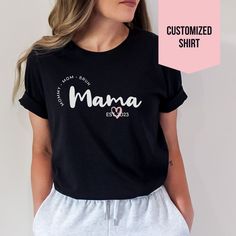 This personalized Mama T-Shirt is the perfect gift for your mom or a soon be a mom. Made from jersey cotton and available in 7 sizes, this comfortable tee is available in white, black, light blue, heather mauve, and athletic heather (grey). * Classic fit * White, Black & Light Blue are 100% Cotton * Athletic Heather is 90% cotton, 10% polyester * Heather Mauve 52% cotton, 48% polyester M E A S U R I N G T I P: Take your favorite tee, lay it flat on a surface and measure from armpit to armpit (width) and top to bottom (length), then compare with our size chart. C A R E I N S T R U C T I O N S: * Machine wash cold, inside out on gentle. Lay flat to dry (or tumble dry on low heat) * Do not iron directly on graphic print. Personalized Name Print T-shirt For Mother's Day, Custom Text T-shirt For Mother's Day Personalized Gift, Personalized Mother's Day T-shirt With Custom Text, Custom Text T-shirt For Mother's Day Gift, Mother's Day Personalized Name Print T-shirt, Mother's Day Cotton T-shirt, Mother's Day Anniversary Cotton T-shirt, Cotton T-shirt For Anniversary On Mother's Day, Family Matching Custom Text T-shirt For Personalized Gift