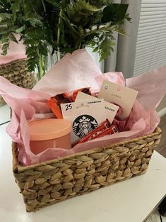 a basket filled with lots of items sitting on top of a table next to a potted plant