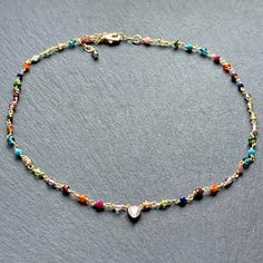 Dainty and colorful gemstone beaded choker necklace for women which I have meticulously hand wire wrapped with rainbow colors and added an adjustable extender chain and a small central diamond heart charm in 14k gold plated. This would make cute semi precious stone Christmas gifts for your sister, girls, Mother's Day or birthday jewelry gift ideas for your daughter, daughter in law, granddaughter or girlfriends. This delicate chain choker is entirely handmade by me with multiple tiny rainbow col Bohemian 14k Gold-filled Jewelry With Colorful Beads, Multicolor Tiny Beads 14k Gold Filled Jewelry, 14k Gold Filled Multicolor Tiny Beads Jewelry, Multicolor Round Beads 14k Gold Filled Jewelry, 14k Gold Filled Multicolor Round Beads Jewelry, Multicolor 14k Gold Filled Round Bead Jewelry, Handmade Multicolor 14k Gold Filled Jewelry, Multicolor 14k Gold-filled Round Beaded Jewelry, Delicate Multicolor Jewelry For Gifts