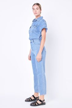 Make a statement in this stylish Short Sleeve Denim Jumpsuit! This jumpsuit has a classic silhouette with short sleeves and a front button-down closure plus two front pockets and a collared neckline for an edgy yet sophisticated look. Perfect for any season this jumpsuit is sure to drive sales and stand out from the rest. Add this unique piece to your wardrobe today! Short sleeves Front button down closure Pockets Collared Machine wash cold Do not bleach Tumble dry low Iron low if needed Shell: Short Sleeve Denim Jumpsuit, Short Sleeve Denim, Jumpsuit Fall, Knit Bottom, Sophisticated Look, Blazer And Shorts, Heat Styling Products, Tops Fall, Low Iron