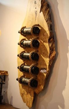 a wooden wine rack with six bottles on it