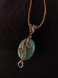 "Beautiful aventurine with unique wire weaved design make this pendant stand out. Treat yourself or a loved one to this unique gift! Comes with a choice of 19\" faux leather necklace with 2\" extender, or 30\" antique copper ball chain." Jade Wire Wrapped Pendant Jewelry, Wire Wrapped Aventurine Jewelry For Gifts, Hand Wrapped Waxed Cord Jewelry As Gift, Wire Wrapped Jewelry With Waxed Cord As Gift, Wire Wrapped Jewelry On Waxed Cord As Gift, Handmade Aventurine Round Pendant Necklace, Gift Wire Wrapped Necklace With Waxed Cord, Gift Jewelry With Wire Wrapped Waxed Cord, Handmade Aventurine Pendant Jewelry