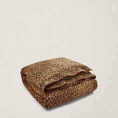 a leopard print comforter set on top of a bed