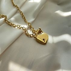 "- Heart Lock Necklace - Today is your day to glam with MayaMore Jewelry! This item is waterproof, nickel-free, and lead-free. This item is made of high-quality materials and it will NOT tarnish nor discolor for a long time. This item is hypoallergenic so it won't irritate sensitive skin. P R O D U C T D E T A I L S Material: Pendant: 18k Gold Plated Stainless Steel, anti-tarnish, hypoallergenic, lead and nickel-free Chain: 18k Gold Plated Stainless Steel, anti-tarnish, hypoallergenic, lead and