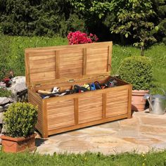 a large wooden box sitting on top of a stone patio