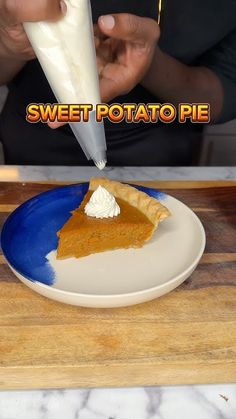 a slice of sweet potato pie on a plate with whipped cream being drizzled over it