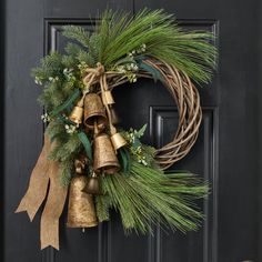 a christmas wreath with bells and greenery