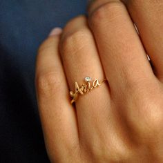 "Beautiful handcrafted 14k Solid Gold name ring. This lovely custom made ring is a perfect accessory to own or gift - for your wife, best friends, brothers, sisters and all of your loved ones :) Important dates/coordinates can also be made. We will send a drawing before starting the manufacturing process so you know what it will look like. * Diamond Color-Clarity Grade : H-I, Vs-Si * Gold - 14k Solid Gold SENDING AS A GIFT We would be happy to send your gift directly to the recipient, including Personalized Diamond Initial Ring, Custom Name Yellow Gold Jewelry For Anniversary, Personalized 14k Gold Rings Fine Jewelry, Personalized Gold Sterling Silver Birthstone Ring, Personalized 14k Gold Fine Rings, Custom Name Engraved 14k Gold Ring, Elegant Personalized Birthstone Ring For Anniversary Gift, Personalized Engraved 14k Gold Ring, Personalized Luxury Diamond Ring For Anniversary