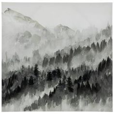 a black and white photo of mountains with trees in the foreground, on a foggy day