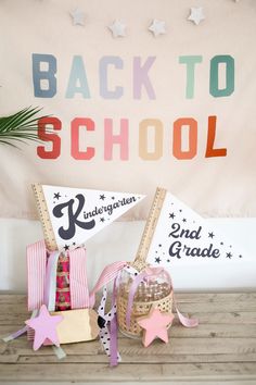 back to school decorations on a wooden table in front of a wall with the words back to school