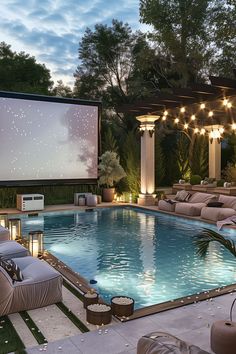 an outdoor movie is set up next to a swimming pool with lounge chairs around it