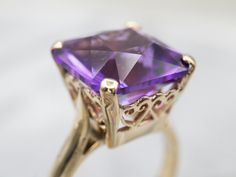 This cocktail ring is the perfect accessory for any occasion! Featuring an eye-catching amethyst in a dashing solitaire setting, this ring is sure to make heads turn! Get the party started with a touch of glitz and glamour!Metal: 14K Yellow GoldGem: Amethyst 9.30 CaratsGem Measurements: 13.1 mm, Square Ring Size: 8Marks: "14K" Stamped on the inside band Elegant Amethyst Birthstone Ring With Prong Setting, Elegant Purple Birthstone Ring With Center Stone, Elegant Amethyst Promise Ring With Accent Stones, Elegant Amethyst Wedding Ring, Elegant Purple Round Cut Birthstone Ring, Elegant Purple Gemstone Birthstone Ring, Elegant Purple Solitaire Birthstone Ring, Elegant Wedding Amethyst Ring, Elegant Purple Birthstone Ring With Round Cut