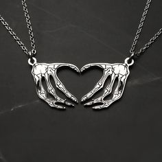 Skeleton Heart Hands Necklaces, perfect for couples! Our unique, matching necklaces showcase a modern, edgy design that will surely stand out. These necklaces will make a great statement piece and a memorable gift for any couple. I T E M ∙ D E T A I L S ♥ quantity: a set of 2 ♥ finish: silver, gold, rose gold ♥ material: stainless steel  ♥ chain length: 18"+2.5" for extender ♥ pendant size: 1.1" x 0.6" ♥ fonts:  standard (by default), classic, holy, cursive, kaufmann, old london ♥ engraving: can be personalized with any symbol, names, initials, dates, roman numerals on the back side of the card. H O W ∙ T O ∙ O R D E R 1. Select options from the dropdown menu 2. Add to cart and proceed to checkout 3. Submit your personalization request in the buyer's note section during checkout. The defau Matching Skeleton Necklace, Necklaces For Couples, Skeleton Heart Hands, Matching Necklaces For Couples, Skeleton Heart, Handwriting Bracelet, Coordinates Bracelet, Card Necklace, Gothic Gifts