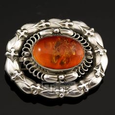 Designed by: Georg Jensen (1866-1935) around 1910. The item is pre-owned and has a very small dent where the amber meets the silver (see photo). Not really visible when worn. Apart from that in perfect condition. | eBay! Classic Oval Cabochon Brooches, Classic Oval Brooches For Collectors, Classic Oval Silver Brooches, George Jensen, Georg Jensen Jewelry, Georg Jensen Silver, Scottish Jewellery, Nouveau Jewelry, Art Nouveau Jewelry