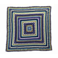 a blue and green crocheted square on a white background, with the center surrounded by smaller squares