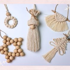 macrame beads and tassels are arranged on a white surface with the word love spelled out