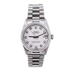 Women's Midsize Rolex 31mm DateJust 18K White Gold Watch with Pink Diamond Dial and Fluted Bezel. Pre-Owned SN# N11**** Brand: Rolex. Gender: Ladies. Dial Color: Pink. Crystal: Sapphire. Dial: Diamond Dial. Model Number: 68279. Bracelet / Strap: Jubilee. Metal Type: 18K White Gold. Case Dimensions: Midsize 31mm. Movement: Self-Winding (Automatic). Box / Certificate: Rolex Box / Certificate of Authenticity. Service Warranty: One (1) Year Limited Service Warranty. Rolex 31mm Datejust, Corum Watches, White Gold Watch, Patek Philippe Mens, Zenith Watches, Rolex Watches Women, Rolex Women, Hublot Watches, Chanel Watch