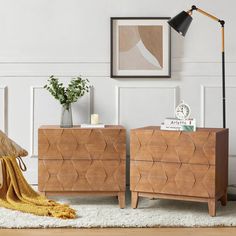 two wooden dressers sitting next to each other on a rug in front of a white wall