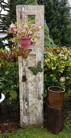 an old door is decorated with flowers and butterflies