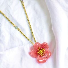 This necklace is a blooming beauty. The delicate design of an enamel plum blossom adorning the clavicle adds a touch of elegance to any outfit. Bring a little floral flair to your wardrobe and make a statement with this unique piece. Collection: Garden Series Product Type: Necklace Material: 18k gold plating brass, enamel Charm Dimensions: Height: 20 mm, Width: 20 mm Necklace length: 41 cm + 5.5 cm / 16.1 inches + 2.2 inches (Adjustable Chain) Feminine Blossom Jewelry For Spring, Enamel Jewelry For Spring Gifts, Dainty Blossom Color Jewelry For Spring, Blossom Flower Jewelry For Spring, Dainty Blossom Jewelry For Spring, Gold Flower Pendant Necklace For Spring, Spring Enamel Jewelry As Gift, Spring Enamel Jewelry For Gifts, Feminine Spring Jewelry Gift