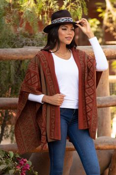 In complementary hues of burnt sienna pumpkin and chestnut alpaca yarns combine to create intricate swirl and geometric patterns. Peruvian artisan Waldo Berrios draws inspiration from traditional Inca textiles as he creates this knit hooded ruana which is given a reversible pattern. Poncho Design, Black And White Leaves, Alpaca Scarf, Long Black Coat, Wool Wrap, Alpaca Yarn, New Fashion Trends, Swirl Pattern, Red And Grey