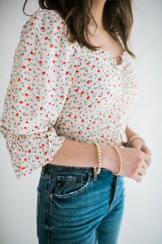 Our Parker floral top brings the ultimate femme vibes to your outfit. This beautiful top has is ruched in the front and has smocking in the back. It has a scoop neckline and can be worn both on and off the shoulder. The flowly sleeves add extra elegance to this simple top. With multiple ways to wear and style this top it is sure to be a go to. Size Chart Features: scoop neckline smocking in the back puff sleeve ruched front detail model is wearing a small. Height 5'7", Bust 34", Waist 25", Hip 3 Simple Top, Denim Accessories, Floral Top, Dress Romper, Bottoms Pants, Scoop Neckline, Short Tops, Smocking, Puff Sleeve