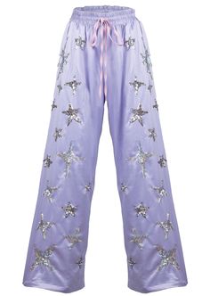 Bring some magic to your wardrobe with our Lilac Stardust Silky Lounge Pants. Made with soft dove satin, these wide leg pants feature hand-beaded galaxies of holographic and silver stars. Each star is carefully hand-embroidered, guaranteed to twinkle in the sunlight. If you want your life to have more magic in it- you can start with your clothes! Galaxy Outfit, Headpiece Accessories, Mermaid Lagoon, Land For Sale, Silver Stars, Lounge Pants, Stardust, Skirt Pants, Leg Pants