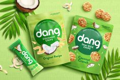 two bags of dang coconut chips next to some leaves and nuts on a green background